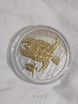 2012 1 oz Fiji Taku plaqué or. Pièce en argent 999 proof avec certificat d’authenticité et emballage d’origine de la Monnaie