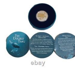 2012 1 oz Fiji Taku plaqué or. Pièce en argent 999 proof avec certificat d’authenticité et emballage d’origine de la Monnaie