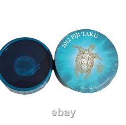 2012 1 oz Fiji Taku plaqué or. Pièce en argent 999 proof avec certificat d’authenticité et emballage d’origine de la Monnaie
